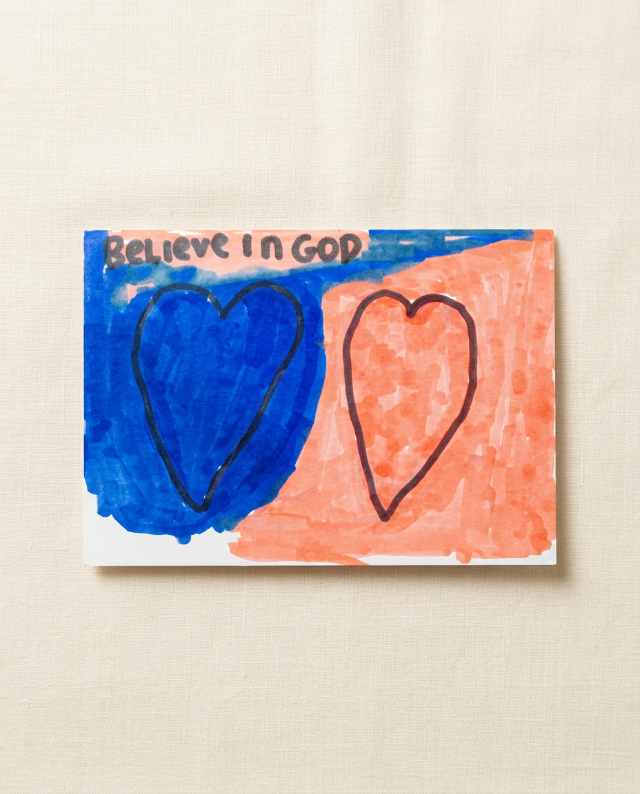 Handmade 'Believe in God' card by Andrew Leicht with a blue heart and a coral heart.